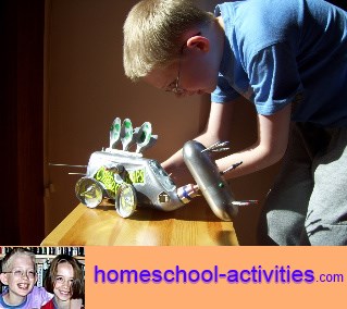 child building a dinosaur robot