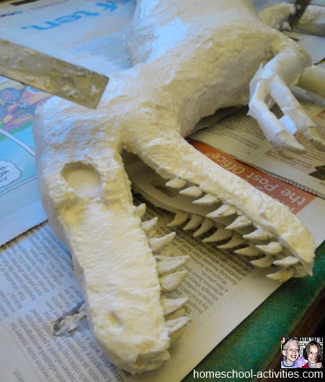 adding paper mache clay to Velociraptor